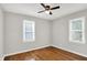 The bedroom has hardwood floors, ceiling fan, neutral paint, and two windows at 1722 Dawson St, Indianapolis, IN 46203