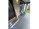 Charming front porch showcasing a blue and white welcome mat and blue Adirondack chairs at 1722 Dawson St, Indianapolis, IN 46203
