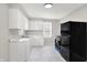 Bright kitchen featuring white cabinets, sleek marble countertops, and stainless steel appliances at 1722 Dawson St, Indianapolis, IN 46203