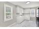 Spacious kitchen featuring white cabinetry, marble countertops, and new stainless steel appliances, including a gas range at 1722 Dawson St, Indianapolis, IN 46203