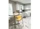 Eat-in kitchen featuring white cabinets and yellow counter stools at 1722 Dawson St, Indianapolis, IN 46203