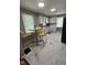Well-lit kitchen features marble floors, stainless steel sink, and white cabinets at 1722 Dawson St, Indianapolis, IN 46203