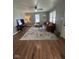Bright living room features hardwood floors, ceiling fan, and a large window at 1722 Dawson St, Indianapolis, IN 46203