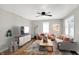 Bright living room features a ceiling fan, hardwood floors, and neutral decor at 1722 Dawson St, Indianapolis, IN 46203