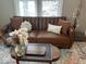 Cozy living room featuring a brown leather sofa and accent pillows at 1722 Dawson St, Indianapolis, IN 46203