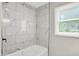 Bathroom has a modern white tiled shower and a window for natural light at 1722 Dawson St, Indianapolis, IN 46203