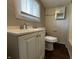 Bathroom with modern vanity, updated fixtures, and wood-look flooring at 1730 N Graham Ave, Indianapolis, IN 46218