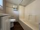 Bathroom featuring a tub/shower combo, modern vanity, and wood-look floors at 1730 N Graham Ave, Indianapolis, IN 46218
