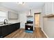 Bright kitchen with stainless steel appliances, updated cabinets, and a view into the connecting bathroom at 1730 N Graham Ave, Indianapolis, IN 46218