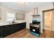 Well-equipped kitchen featuring updated appliances, sleek dark cabinets, and modern fixtures at 1730 N Graham Ave, Indianapolis, IN 46218