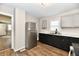 Modern kitchen with stainless steel refrigerator, dark cabinets, and marble-look countertops at 1730 N Graham Ave, Indianapolis, IN 46218