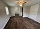 Living room featuring wood-look floors and a view into the bright kitchen at 1730 N Graham Ave, Indianapolis, IN 46218