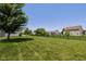 Spacious fenced backyard with lush green grass and mature trees at 1854 Oconnor Ct, Avon, IN 46123
