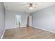 Large bedroom with wood-look floors and ensuite bathroom and walk-in closet entrances at 1854 Oconnor Ct, Avon, IN 46123