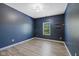 Bedroom with navy accent wall, two shelves, and wood-look floors at 1854 Oconnor Ct, Avon, IN 46123