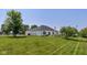 Rear exterior view of a home featuring a spacious, fenced yard and patio at 1854 Oconnor Ct, Avon, IN 46123