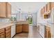 Bright kitchen features wood cabinets, a white dishwasher, and a view into the dining room at 1854 Oconnor Ct, Avon, IN 46123