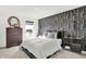 Modern bedroom with gray wallpaper accent wall, stylish furnishings, and plenty of natural light from the window at 19811 Moorpark Lndg, Noblesville, IN 46062