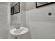 Clean, white bathroom with subway tile, a pedestal sink, and modern fixtures, offering a simple and elegant design at 19812 Moorpark Lndg, Noblesville, IN 46062