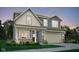 Inviting two-story home with a neutral color palette, two-car garage, well-manicured landscaping, and charming front porch at 19831 Moorpark Lndg, Noblesville, IN 46062