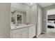 Bright bathroom features double sinks, large mirror, and view into the main bedroom at 19843 Moorpark Lndg, Noblesville, IN 46062