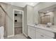 Modern bathroom featuring double vanity sinks, granite countertop, and open closet space at 19843 Moorpark Lndg, Noblesville, IN 46062
