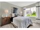 Cozy bedroom with neutral tones, a comfortable bed, and a large window with natural light at 19843 Moorpark Lndg, Noblesville, IN 46062