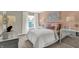 Comfortable bedroom features a plush bed, decorative pillows, and bright window at 19843 Moorpark Lndg, Noblesville, IN 46062