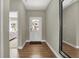 Bright foyer with wood flooring, a white front door, and a view into a bedroom at 19843 Moorpark Lndg, Noblesville, IN 46062
