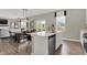 Open-concept kitchen with island seating, seamlessly flowing into the dining and living areas at 19843 Moorpark Lndg, Noblesville, IN 46062