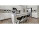 Bright kitchen featuring white cabinets, a large island with seating, and modern appliances at 19843 Moorpark Lndg, Noblesville, IN 46062
