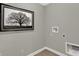 Laundry room corner showing hookups, outlets, tile floor, and decorative nature print at 19843 Moorpark Lndg, Noblesville, IN 46062
