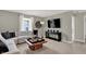 Cozy living room with a plush sectional sofa, decorative accents, and large window at 19843 Moorpark Lndg, Noblesville, IN 46062