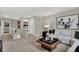 Bright open living room featuring neutral colors, a plush sofa, and modern artwork at 19843 Moorpark Lndg, Noblesville, IN 46062