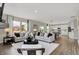 Open-concept living room with modern furniture, a fireplace, and a view into the dining area at 19843 Moorpark Lndg, Noblesville, IN 46062
