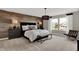 Stylish main bedroom featuring modern lighting, a plush bed, and an accent wall at 19843 Moorpark Lndg, Noblesville, IN 46062