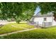 Backyard with a green lawn, a small patio, and some shade trees at 201 N 11Th St, Elwood, IN 46036