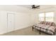 Upstairs bedroom with ceiling fan, neutral carpet, and a window for natural light at 201 N 11Th St, Elwood, IN 46036