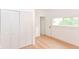 Bright bedroom featuring hardwood floors, bi-fold closet doors, and a window providing natural light at 201 N 11Th St, Elwood, IN 46036