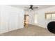 Bright bedroom featuring a ceiling fan, neutral carpet, and closet at 201 N 11Th St, Elwood, IN 46036