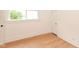 Well-lit bedroom with hardwood floors, white walls, and a window offering natural light at 201 N 11Th St, Elwood, IN 46036