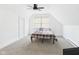 Cozy bedroom features plush carpet, a ceiling fan, and a bright window at 201 N 11Th St, Elwood, IN 46036