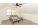 Attic bedroom with ceiling fan, neutral carpet, and a window for natural light at 201 N 11Th St, Elwood, IN 46036