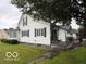 Charming two-story house with vinyl siding and black shutters at 201 N 11Th St, Elwood, IN 46036