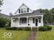 Charming home features a cozy front porch and well-maintained landscaping at 201 N 11Th St, Elwood, IN 46036