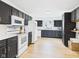 Modern kitchen with stainless steel appliances, dark cabinets, and granite countertops at 201 N 11Th St, Elwood, IN 46036