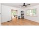 A bright living room featuring stylish wood flooring and modern ceiling fan at 201 N 11Th St, Elwood, IN 46036