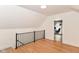 Cozy loft area with light wood floors, neutral walls, and access to another room at 201 N 11Th St, Elwood, IN 46036