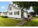 A view of the side and rear of the house with a small outdoor patio space at 201 N 11Th St, Elwood, IN 46036