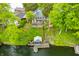 Aerial view of the waterfront property with a charming boathouse and private dock, providing stunning lake access at 242 W Warford Dr, , IN 46164